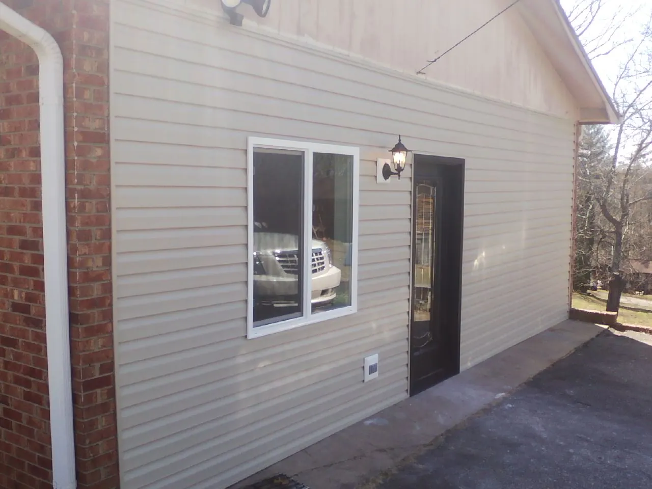 New vinyl siding and entry door on a room addition in Scotland Neck